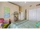 Inviting bedroom featuring a decorative shelf, colorful accents, and a comfortable queen-sized bed at 4055 N Recker Rd # 82, Mesa, AZ 85215
