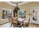 Dining area with wood table, industrial chairs, large windows, and backyard views at 4055 N Recker Rd # 82, Mesa, AZ 85215
