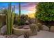 Inviting outdoor seating area with fireplace, perfect for relaxing amongst desert landscaping at 4055 N Recker Rd # 82, Mesa, AZ 85215