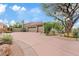 Home exterior featuring a three-car garage, desert landscaping, and a circular driveway at 4055 N Recker Rd # 82, Mesa, AZ 85215