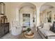 Cozy living room with elegant columns, comfortable seating, and a view into the bedroom at 4055 N Recker Rd # 82, Mesa, AZ 85215