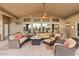 Covered outdoor seating area with ceiling fan, comfortable seating, and a fire pit at 4055 N Recker Rd # 82, Mesa, AZ 85215