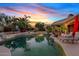 Backyard pool with mature landscaping, basketball hoop, lounge seating and a covered patio at 4055 N Recker Rd # 82, Mesa, AZ 85215