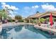 Relax and unwind in your own backyard with a sparkling pool, lush landscaping, and a covered patio at 4055 N Recker Rd # 82, Mesa, AZ 85215