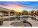 Backyard pool with sunset views, covered patio, outdoor seating, desert landscaping, and attached spa at 4055 N Recker Rd # 82, Mesa, AZ 85215