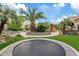 The backyard boasts a sunken trampoline, lush greenery, patio, and mature trees providing shade and privacy at 4055 N Recker Rd # 82, Mesa, AZ 85215