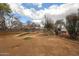 This spacious backyard has a rustic seating area under bare trees, and a gravel landscape at 4117 W Sierra Vista Dr, Phoenix, AZ 85019