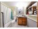 This eclectic bathroom features a unique sink, an industrial mirror, and a shower-tub combo at 4117 W Sierra Vista Dr, Phoenix, AZ 85019