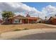 Charming single-story brick home with a well-manicured front yard, flag, and covered parking at 4117 W Sierra Vista Dr, Phoenix, AZ 85019
