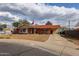 Charming single-story brick home with a well-manicured front yard, flag, and covered parking at 4117 W Sierra Vista Dr, Phoenix, AZ 85019