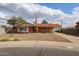 Charming single-story brick home with a well-manicured front yard, flag, and covered parking at 4117 W Sierra Vista Dr, Phoenix, AZ 85019