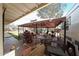 A covered patio offers outdoor relaxation with comfortable seating, a grill, and partial shade from the sun at 4117 W Sierra Vista Dr, Phoenix, AZ 85019