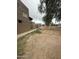 Exterior image of a home with tan stucco walls and a sidewalk leading toward the rear at 4219 N 69Th N Ln # 1319, Phoenix, AZ 85033