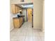 An eat-in kitchen featuring stainless steel appliances, a large window, tile flooring, and light-colored wood cabinets at 4219 N 69Th N Ln # 1319, Phoenix, AZ 85033