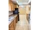 Well-lit kitchen featuring tile flooring, stainless steel appliances, and wood cabinets at 4219 N 69Th N Ln # 1319, Phoenix, AZ 85033