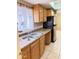 The kitchen features a stainless steel refrigerator, double sink, and light wood cabinets at 4219 N 69Th N Ln # 1319, Phoenix, AZ 85033
