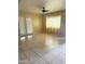 Spacious living room featuring tile flooring, a ceiling fan, and natural light streaming through the large window at 4219 N 69Th N Ln # 1319, Phoenix, AZ 85033