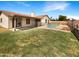 Spacious backyard with well maintained lawn, a swimming pool, and covered patio perfect for outdoor relaxation at 4247 N 101St Ave, Phoenix, AZ 85037