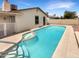 A private backyard features a pool with a small spa and a covered patio at 4247 N 101St Ave, Phoenix, AZ 85037