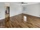 A bedroom featuring a ceiling fan, wood-look flooring and a window, offering a blend of comfort and style at 4247 N 101St Ave, Phoenix, AZ 85037