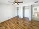 A bedroom featuring a ceiling fan, closet, and wood-look flooring, offering a blend of comfort and style at 4247 N 101St Ave, Phoenix, AZ 85037