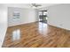 A bedroom featuring a ceiling fan, wood-look flooring, window, and access to the backyard at 4247 N 101St Ave, Phoenix, AZ 85037