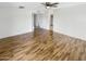 A bedroom featuring a ceiling fan, wood-look flooring and access to the bathroom at 4247 N 101St Ave, Phoenix, AZ 85037