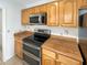 Well-equipped kitchen featuring stainless steel appliances, and wood cabinets at 4247 N 101St Ave, Phoenix, AZ 85037