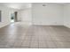 Open-concept living area with tile flooring, neutral walls, and sliding door access to backyard at 4247 N 101St Ave, Phoenix, AZ 85037