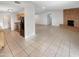 Spacious open-concept living space with tile flooring and a modern kitchen at 4247 N 101St Ave, Phoenix, AZ 85037