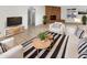 A bright living room featuring a fireplace and modern furniture at 4247 N 101St Ave, Phoenix, AZ 85037