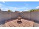 Cozy backyard patio space with brick pavers and string lights, perfect for relaxing and entertaining at 4559 E Sierrita Rd, San Tan Valley, AZ 85143