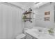 Cozy bathroom featuring a vanity, toilet, and a shower with rustic shelving and decor at 4559 E Sierrita Rd, San Tan Valley, AZ 85143