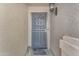 Close-up of front door with security screen and decorative light fixture at 4559 E Sierrita Rd, San Tan Valley, AZ 85143