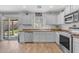 Contemporary kitchen with stainless steel appliances, wood-look flooring, and slider to backyard at 4559 E Sierrita Rd, San Tan Valley, AZ 85143
