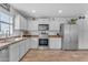 Bright, airy kitchen with white cabinets, stainless steel appliances, and ample counter space at 4559 E Sierrita Rd, San Tan Valley, AZ 85143