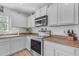 Bright kitchen featuring stainless steel appliances, white cabinets, and modern fixtures at 4559 E Sierrita Rd, San Tan Valley, AZ 85143