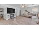 Comfortable living room with ceiling fan, modern decor, and stylish entertainment center at 4559 E Sierrita Rd, San Tan Valley, AZ 85143