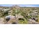 Scenic aerial view of the neighborhood with mature trees, green lawns, and beautiful mountain views at 4813 N 28Th Pl, Phoenix, AZ 85016