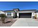Beautiful single-story home featuring a neutral color palette, low maintenance landscaping, and a two-car garage at 5004 S 105Th Ln, Tolleson, AZ 85353