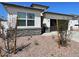 A detailed shot of the exterior of the home shows the stone accents and the well-manicured landscaping at 5004 S 105Th Ln, Tolleson, AZ 85353