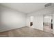 Neutral carpeted bedroom with bathroom access and natural light from the window at 5053 S 252Nd Ave, Buckeye, AZ 85326