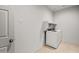 This simple laundry room has a washer, dryer, and built in shelving at 5053 S 252Nd Ave, Buckeye, AZ 85326