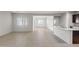 Open-concept living area with tile floors, connecting the kitchen and dining spaces at 5053 S 252Nd Ave, Buckeye, AZ 85326