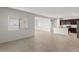 Expansive living room showcasing tile flooring and seamless access to the kitchen at 5053 S 252Nd Ave, Buckeye, AZ 85326