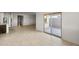 Tile flooring in the living room with view of the sliding glass door to the patio at 5053 S 252Nd Ave, Buckeye, AZ 85326