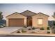 Beautiful desert home with a two-car garage, landscaped yard, and stucco exterior at 5091 S 251St Dr, Buckeye, AZ 85326