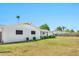 Large grassy backyard surrounded by mature landscaping and a tall palm tree at 512 W Seldon Ln, Phoenix, AZ 85021