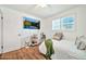 Cozy bedroom with wood floors and a wall-mounted TV for relaxing evenings at 512 W Seldon Ln, Phoenix, AZ 85021