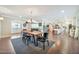 Open-concept dining area with wood floors, a modern chandelier, and seamless flow to the living spaces at 512 W Seldon Ln, Phoenix, AZ 85021